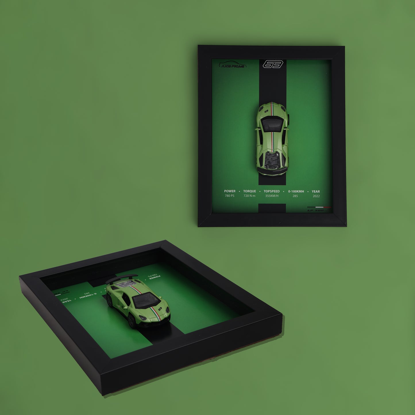 Two black framed displays with green toy cars on a green background
