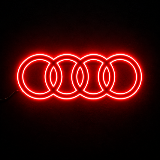 Audi four-ring logo LED wall sign glowing blue against a dark brick wall