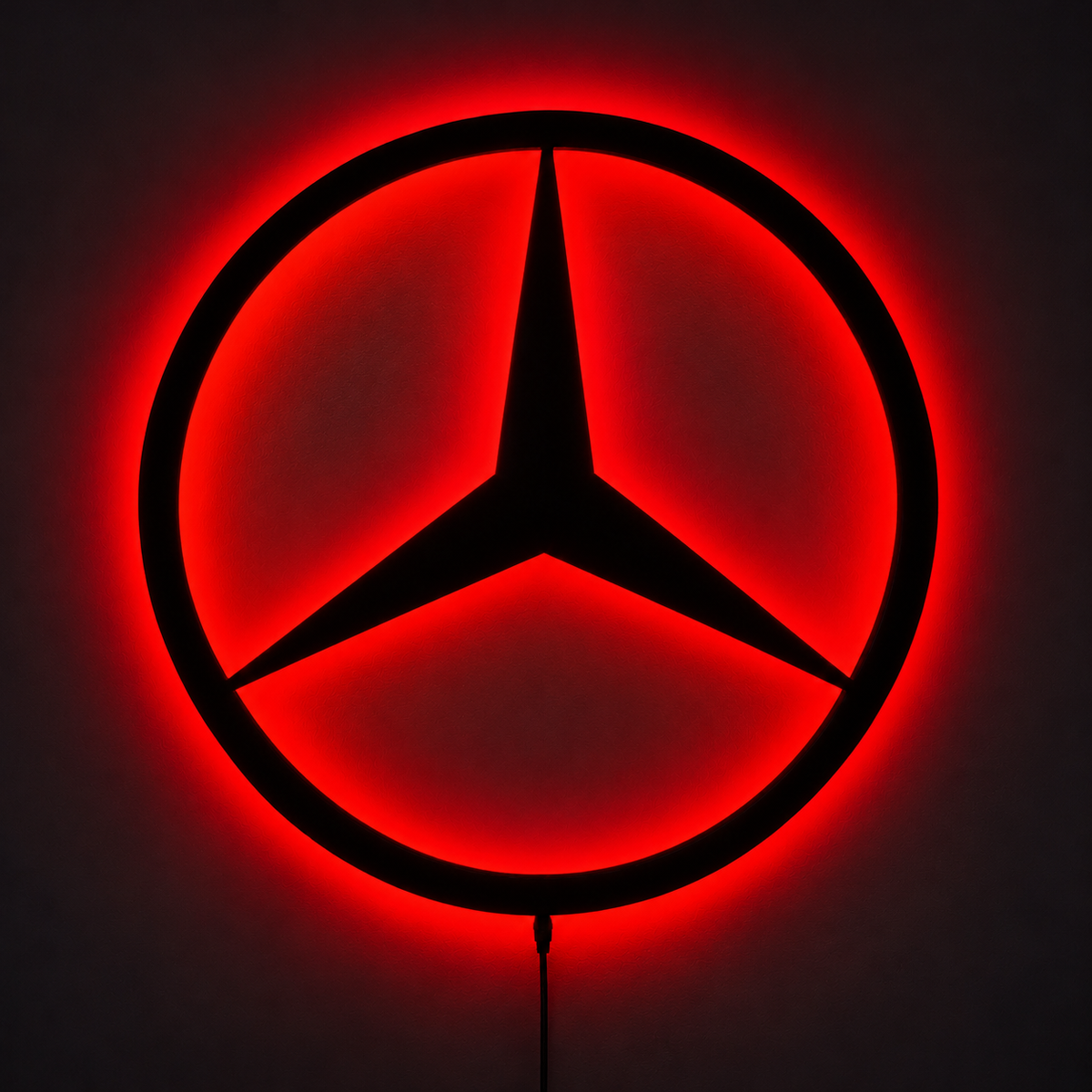 Mercedes-Benz three-pointed star logo LED wall sign with warm yellow backlighting on a white wall