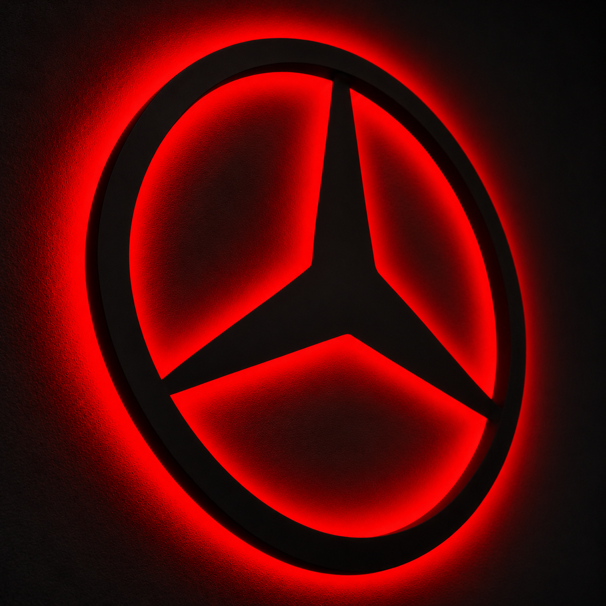 Mercedes-Benz three-pointed star logo LED wall sign with warm yellow backlighting on a white wall