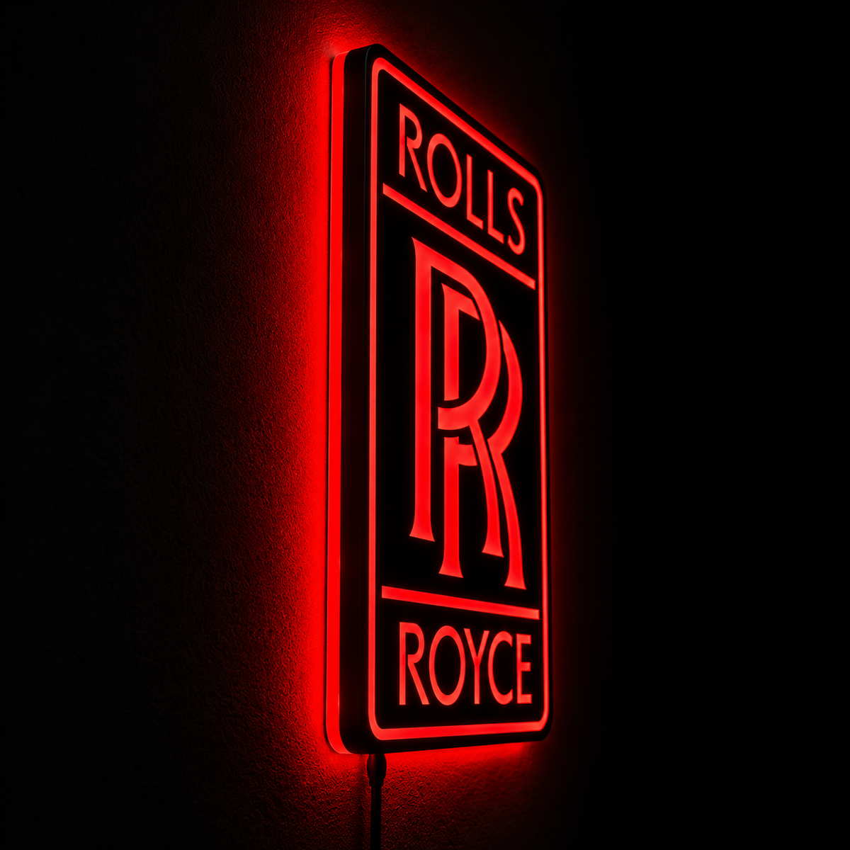 Rolls-Royce logo LED wall sign with golden illumination on a black rectangular plaque against a concrete wall