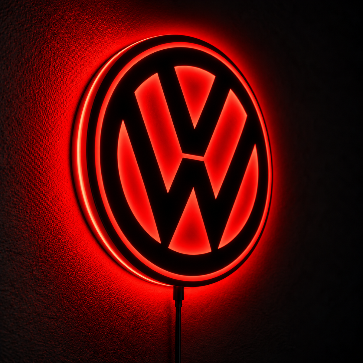 Volkswagen VW logo LED wall sign with warm yellow backlighting on a dark wall, automotive decor for garages and car enthusiasts.
