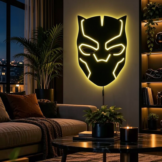 Black Panther-inspired LED wall lamp featuring a black superhero mask with glowing purple and pink backlighting on a brick wall
