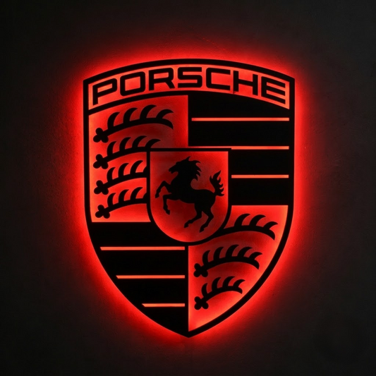 Porsche shield logo LED wall sign with warm golden backlighting on a dark wall