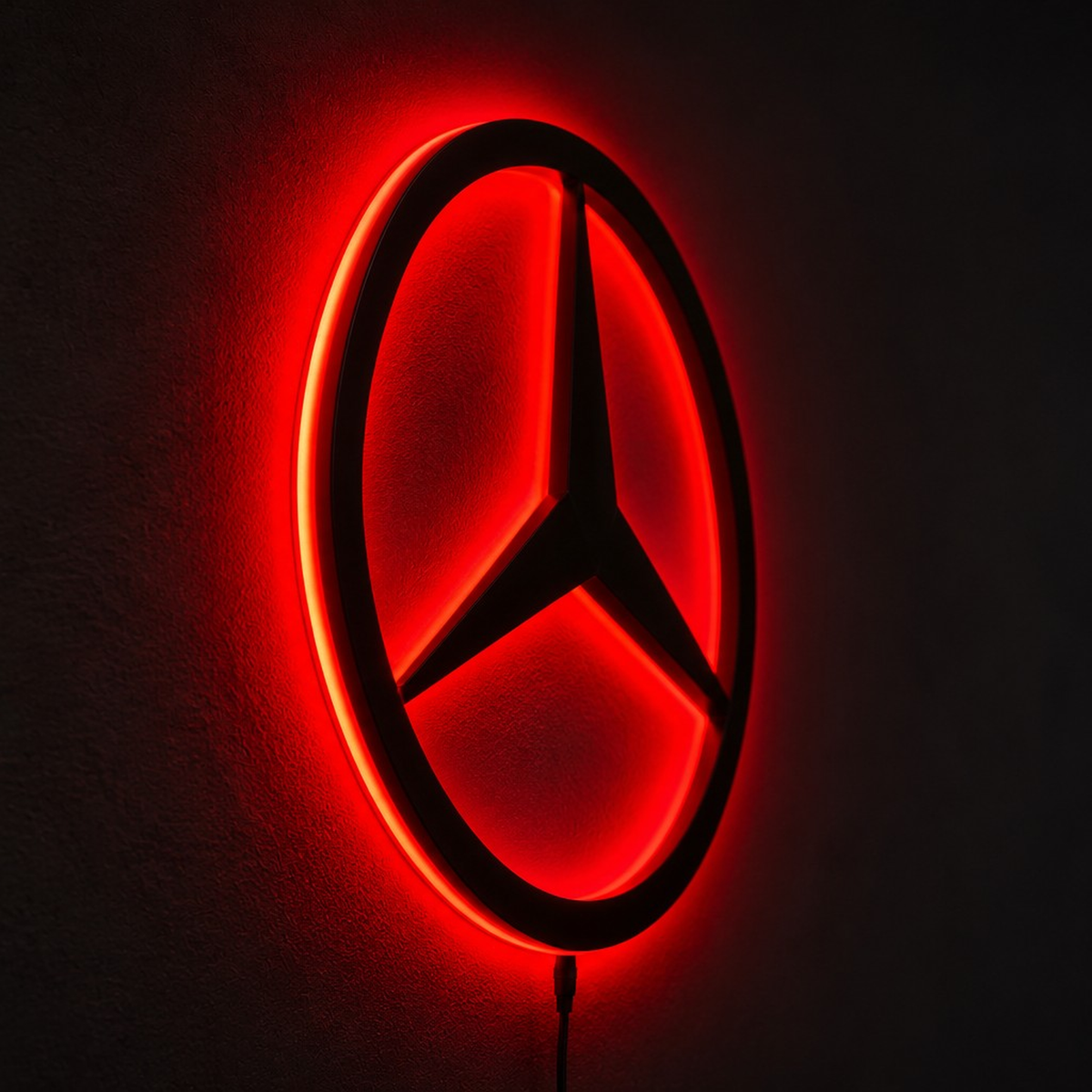Mercedes-Benz three-pointed star logo LED wall sign with warm yellow backlighting on a white wall