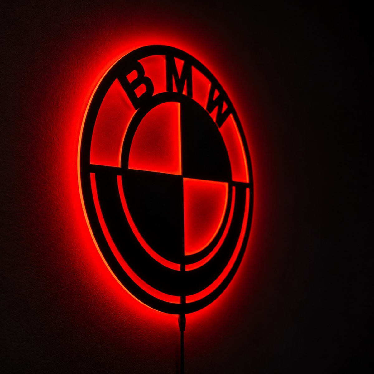 BMW-inspired LED logo wall sign with blue illumination and white backlighting in a modern living room