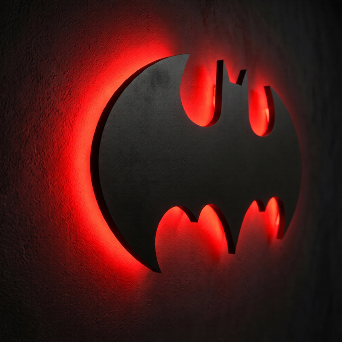 Premium Batman LED wall lamp with warm yellow glowing emblem on dark wall