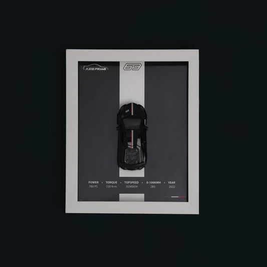 Framed display of a black car model with specifications on a dark background