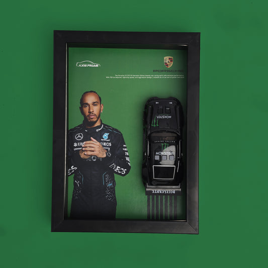 Framed display with a racing driver's portrait and a model car on a green background