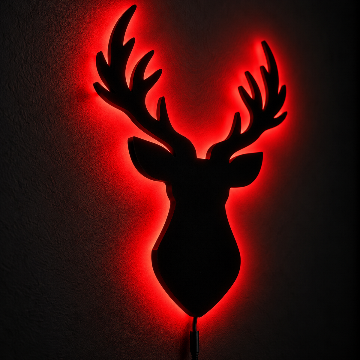 Deer head LED wall lamp with black antler silhouette and warm yellow glowing light against a blue background
