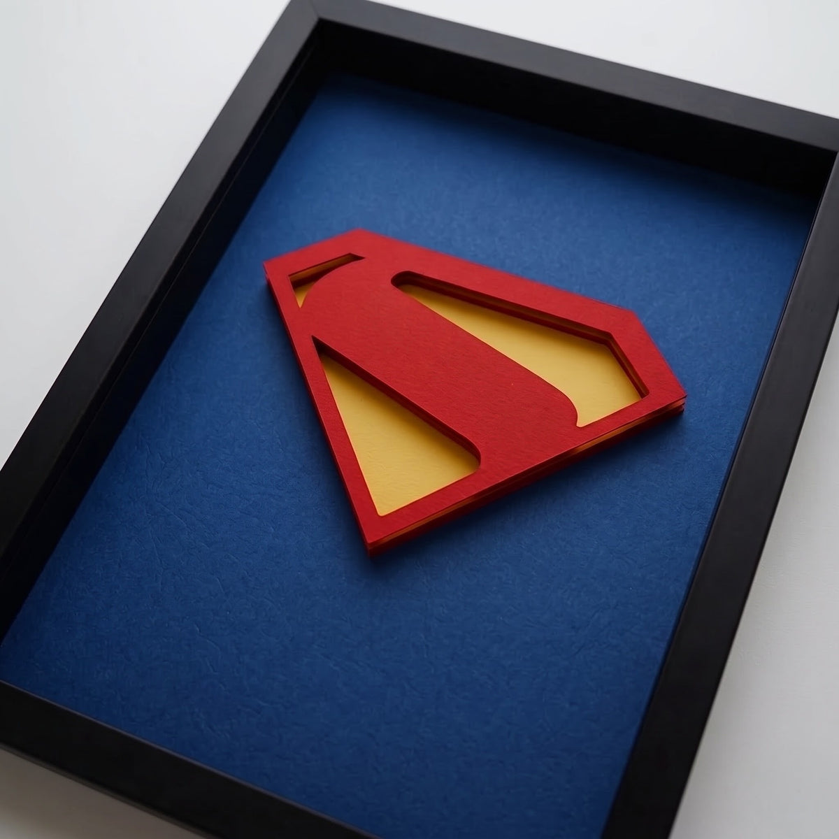 Premium Superman 3D frame with red and yellow emblem on blue background and black shadow box frame