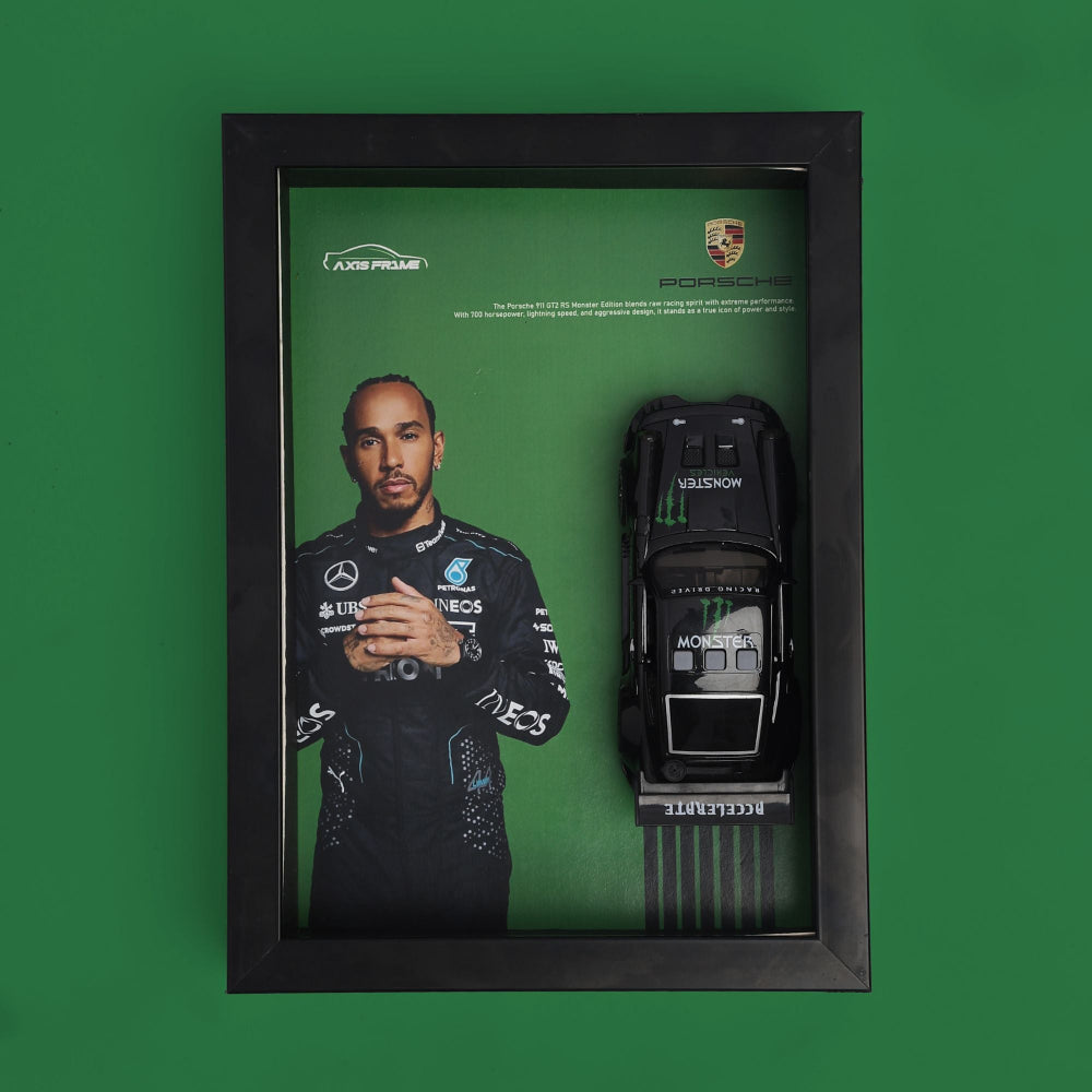 Framed display with a toy car and a portrait of a person on a green background