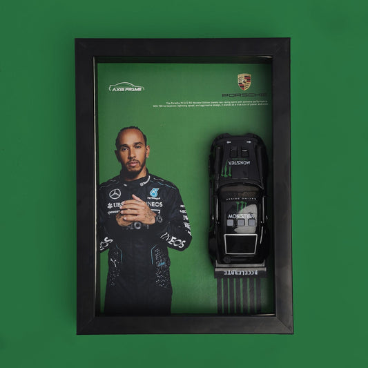 Framed display with a toy car and a portrait of a person on a green background